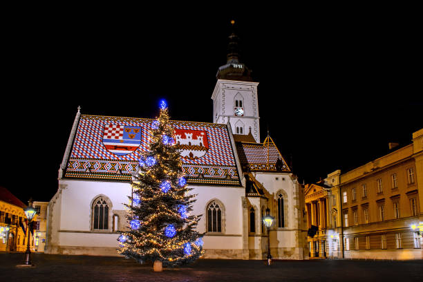 istock Advent in Zagreb - Christmas tree in front St. Mark's Church 1077643090