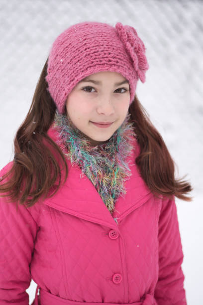 istock Girl in snow winter with pink coat 1077643992