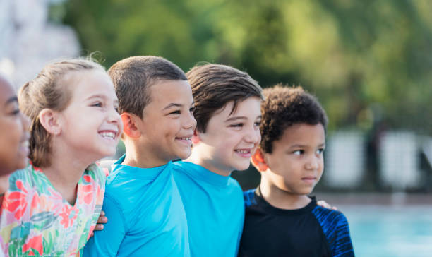 istock Mixed race boy standing with multi-ethnic friends, smiling 1077645736