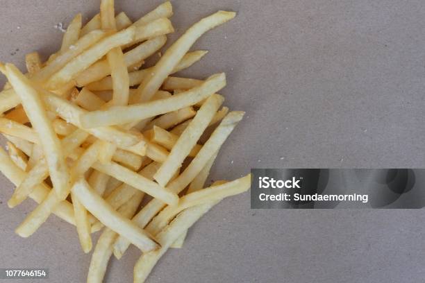 Unhealthy Junk Food Group Of Cheesy French Fries On Brown Paper With Blank Space Copy Space Fast Food Concept Stock Photo - Download Image Now