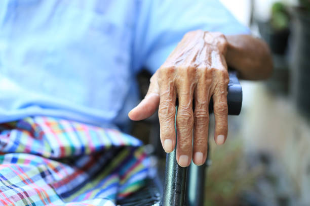 istock Hands of senior man sitting on bench in home 1077647970