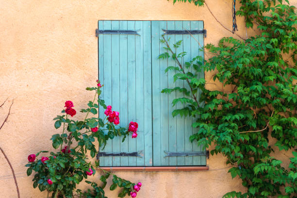 Window with closed shutters and flowers at the village of Lurs in Provence France. Lurs France. 15 september 2018. Window with closed shutters and flowers at the village of Lurs in Provence France. lur stock pictures, royalty-free photos & images