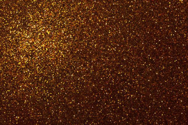 istock Dark golden sparkling background from small sequins, closeup. Brilliant backdrop. 1077650620