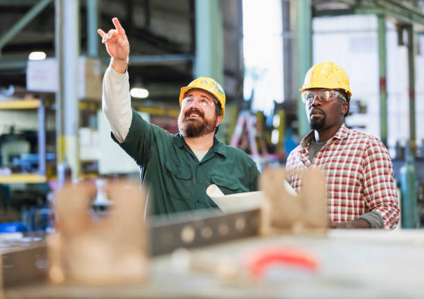 istock Multi-ethnic workers talking in metal fabrication plant 1077654416