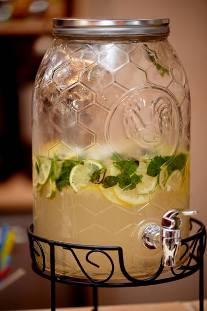 istock Lemonade in a big jar with a tap.Oranges and lemon. Refreshing summer drink 1077654552