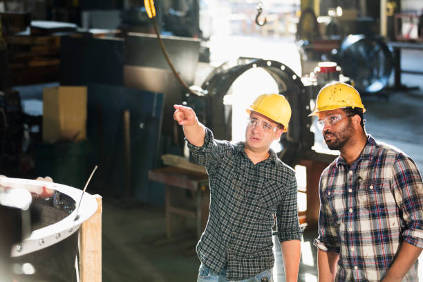 istock Multi-ethnic workers walking in metal fabrication plant 1077655000