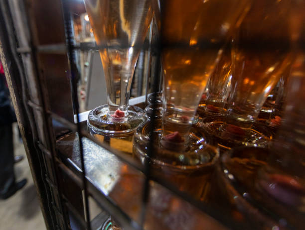 Golden Cava bottles in cellar, traditional way to produce the sparkling wine in catalonia.Lees are deposits of dead yeast or residual yeast and other particles that precipitate, or are carried by the action of \