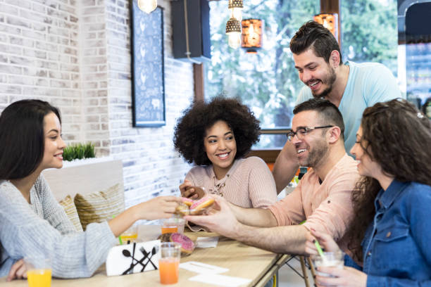 istock Young people enjoying time together in cafe 1077656680