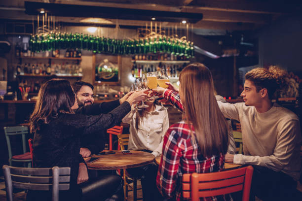 istock People having a toast in pub 1077658378