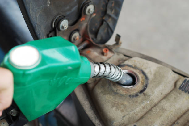 istock Man putting gasoline fuel into his motorcycle 1077660154