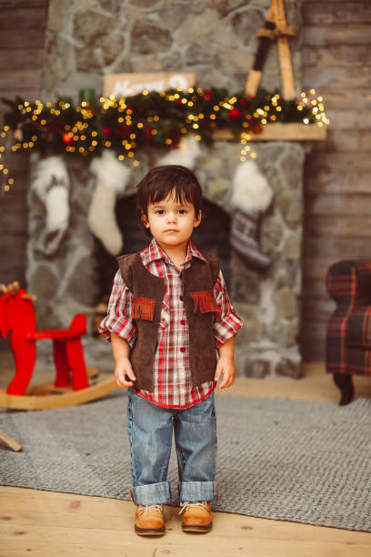 istock Little stylish boy in Christmas decor 1077660220