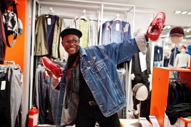 stylish casual african american man at jeans jacket and black beret at clothes store - department store imagens e fotografias de stock