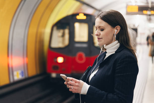 istock Young woman using phone in the subway 1077661666