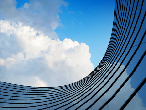 istock Perspective of high rise building and dark steel window system with clouds reflected on the glass.Business concept of future architecture,lookup to the angle of the building corner. 3d rendering 1077661850