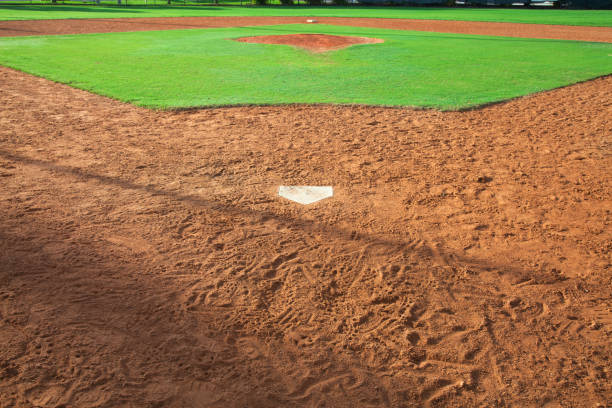 istock Baseball field viewed from behind home plate in morning light 1077665340