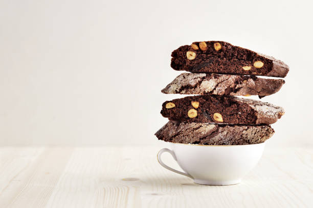 biscotti and coffee,homemade dark chocolate biscotti cookies with hazelnut - baking traditional culture studio shot horizontal imagens e fotografias de stock