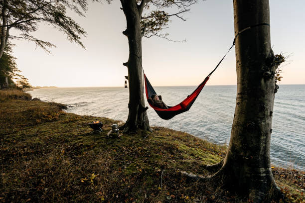 istock Woman lying in a hammock relaxing. 1077665890