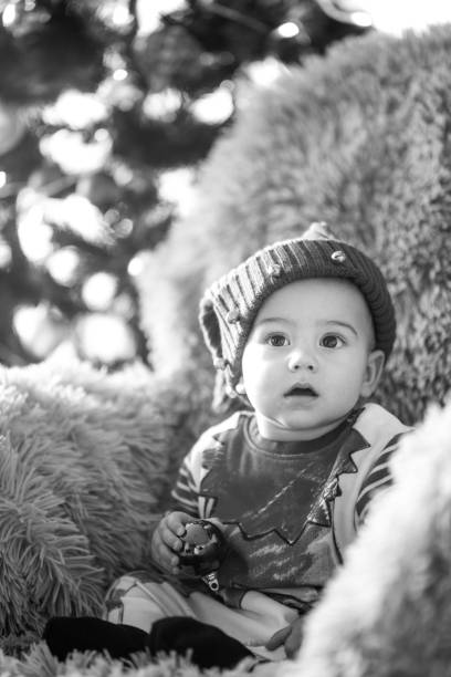 istock Cute baby boy playing with Christmas decoration 1077668560