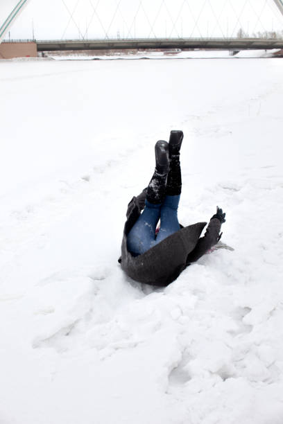 Beautiful woman having Fun on her Sled in the Snow, Austria, Salzkammergut, Ausseerland. Playful natural happy expression. Nikon z7ii. Converted from RAW.
