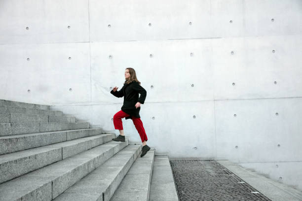istock Woman climbing up the stairs 1077670538