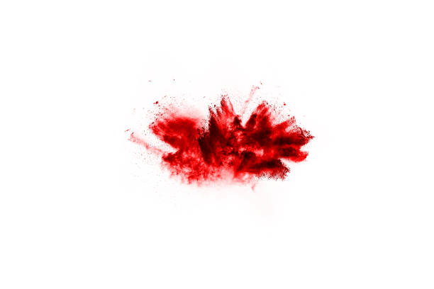 istock Freeze motion of red powder exploding, isolated on white background. Abstract design of red dust cloud. Particles explosion screen saver, wallpaper 1077671598