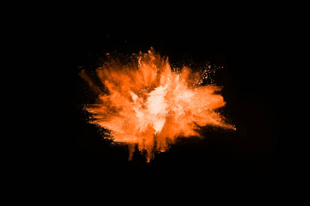 istock Orange powder explosion on black background. Colored cloud. Colorful dust explode. Paint Holi. 1077673490