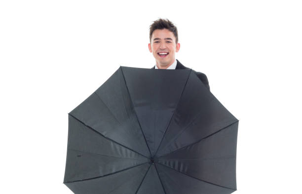 istock Handsome businessman holding an umbrella 1077675020