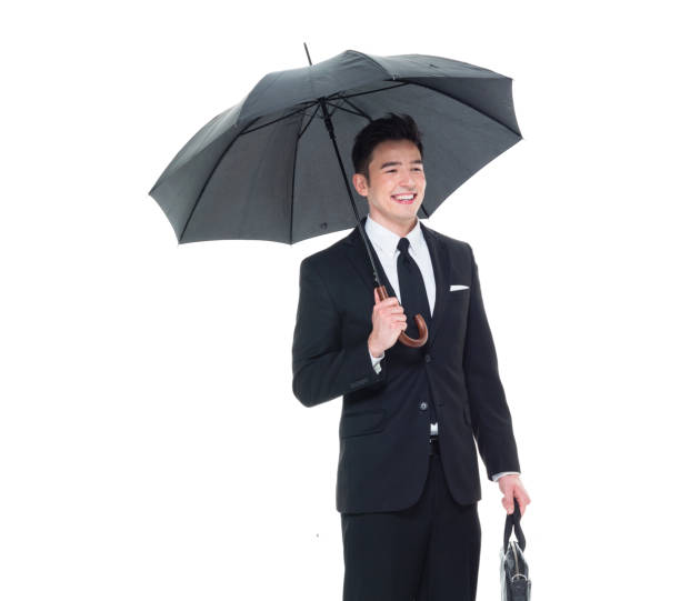 istock Handsome businessman holding an umbrella 1077675090