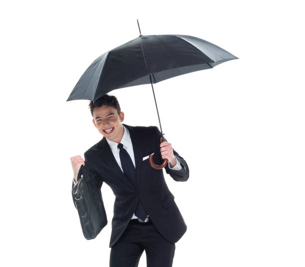 istock Handsome businessman holding an umbrella 1077675094