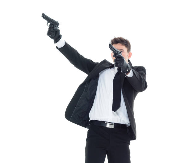 istock Handsome businessman holding a handgun 1077677470
