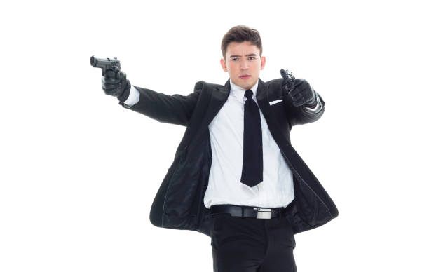 istock Handsome businessman holding a handgun 1077677482