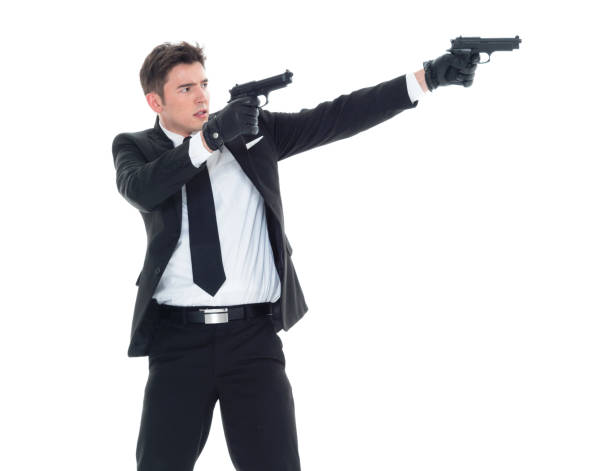 istock Handsome businessman holding a handgun 1077677484