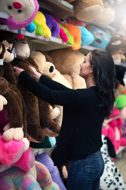 istock Young girl shops for toys 1077683860