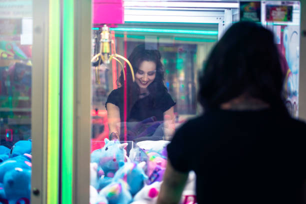 istock Young girl smiles whilst playing arcade games 1077683866