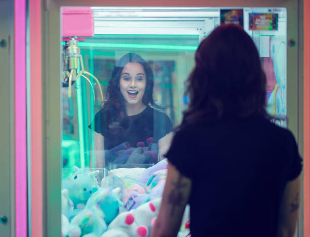 istock Young girl smiles whilst playing arcade games 1077683870