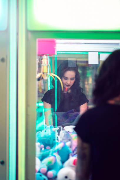 istock Young girl smiles whilst playing arcade games 1077683872