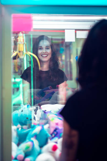 istock Young girl smiles whilst playing arcade games 1077683902