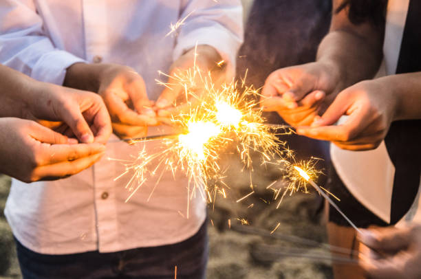 Beautiful sparklers in people hands, xmas and new year concept. stock photo