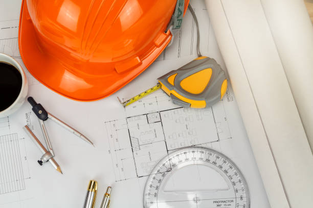istock helmet and etc. on blueprint, architectural concept 1077686706