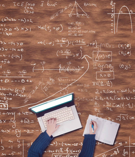 istock Top view of hands on blank paper on a wooden table drawn with a infographs 1077687780