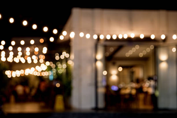 istock Abstract blurred image of night street cafe. 1077689422