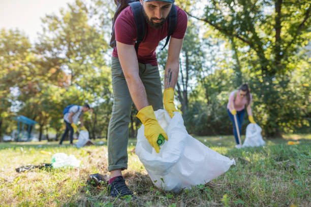 istock Students cleaning garbage in the local park 1077689784