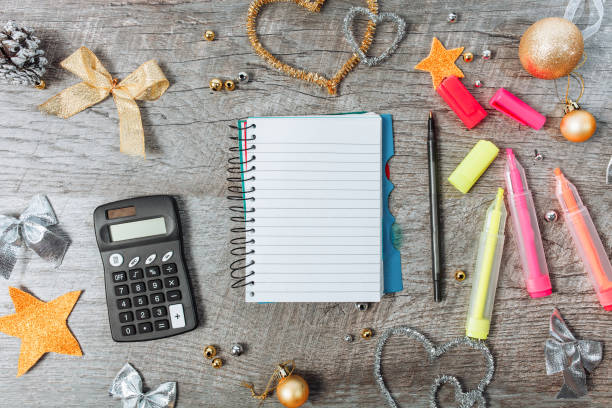 istock View from above. Christmas decoration with an open blank notepad, with a calculator and headphones, planning the new year. 1077690072