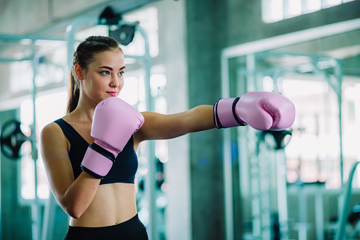 Fit Beautiful Woman Boxer Hitting A Huge Punching Bag Exercise Class In A Gym Boxer Woman Making