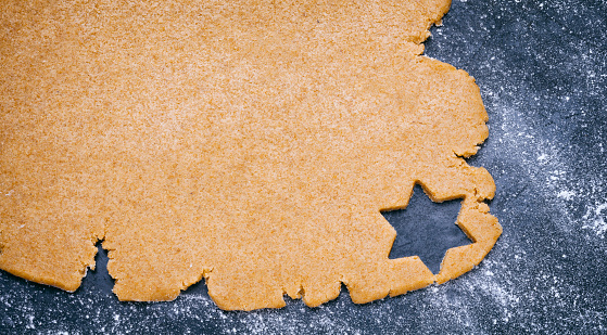 Christmas cookies in the shape of a Christmas tree, a snowman and a gingerbread man on on the table. Close-up. Selective focus.