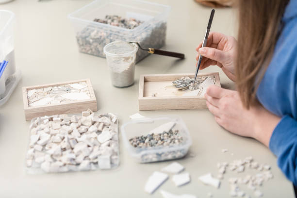 istock Hands Artist working on stones mosaic 1077694200