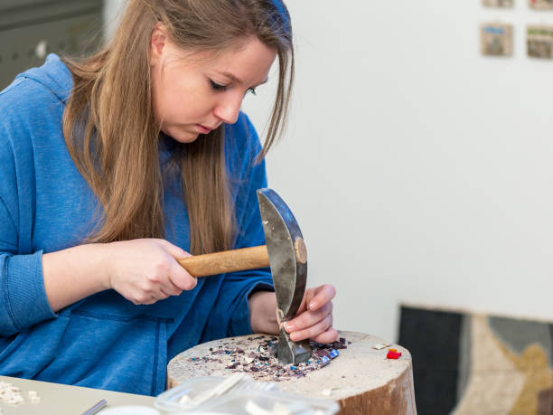 istock Female Artist working on stones mosaic 1077694232
