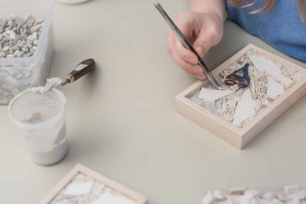 istock Hands Artist working on stones mosaic 1077694262