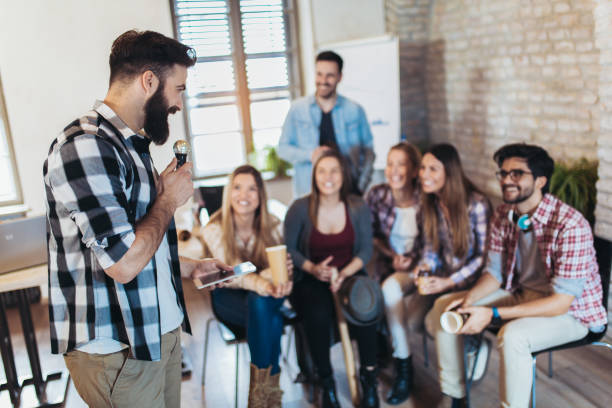 istock Business people singing karaoke in modern office 1077695198