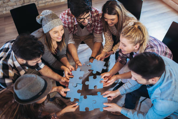 istock Businesspeople joining puzzle pieces in office 1077697506